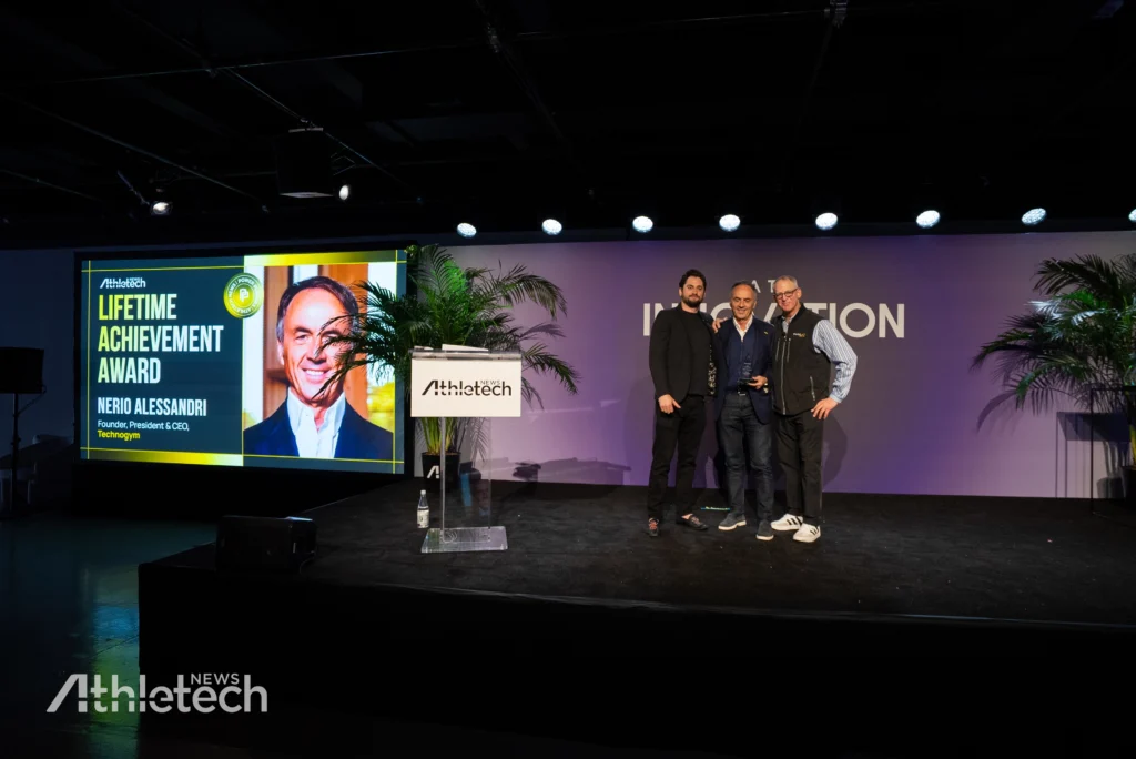 Nerio Alessandri, center, receiving Athletech News’ first-ever Lifetime Achievement Award