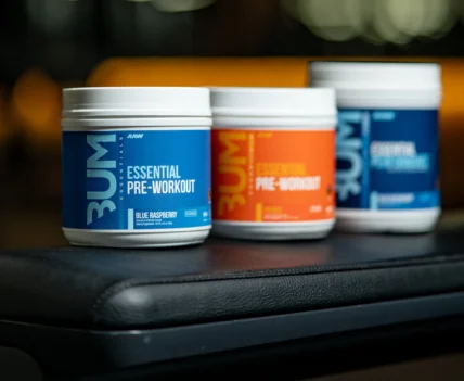 Raw Nutrition supplements displayed on a weightlifting bench
