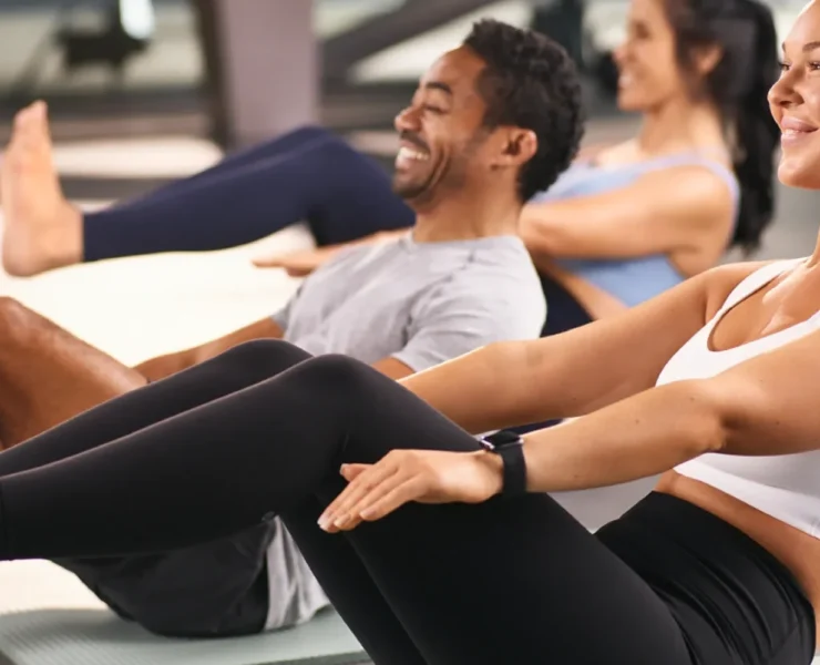 a man and two women doing crunches