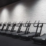 a lineup of treadmills at a gym