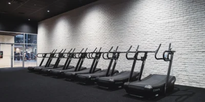 a lineup of treadmills at a gym
