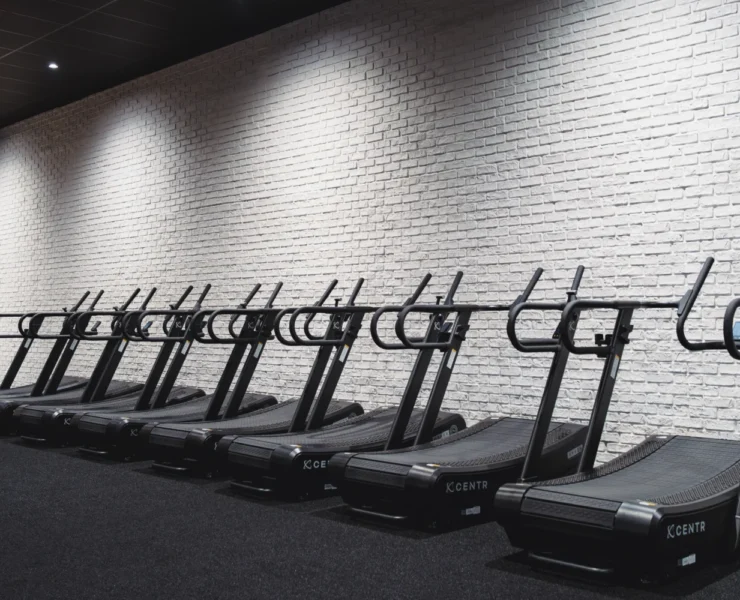 a lineup of treadmills at a gym
