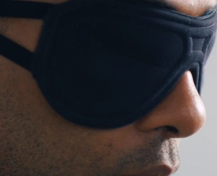 A man wearing a sleep mask from The Inactive Co.