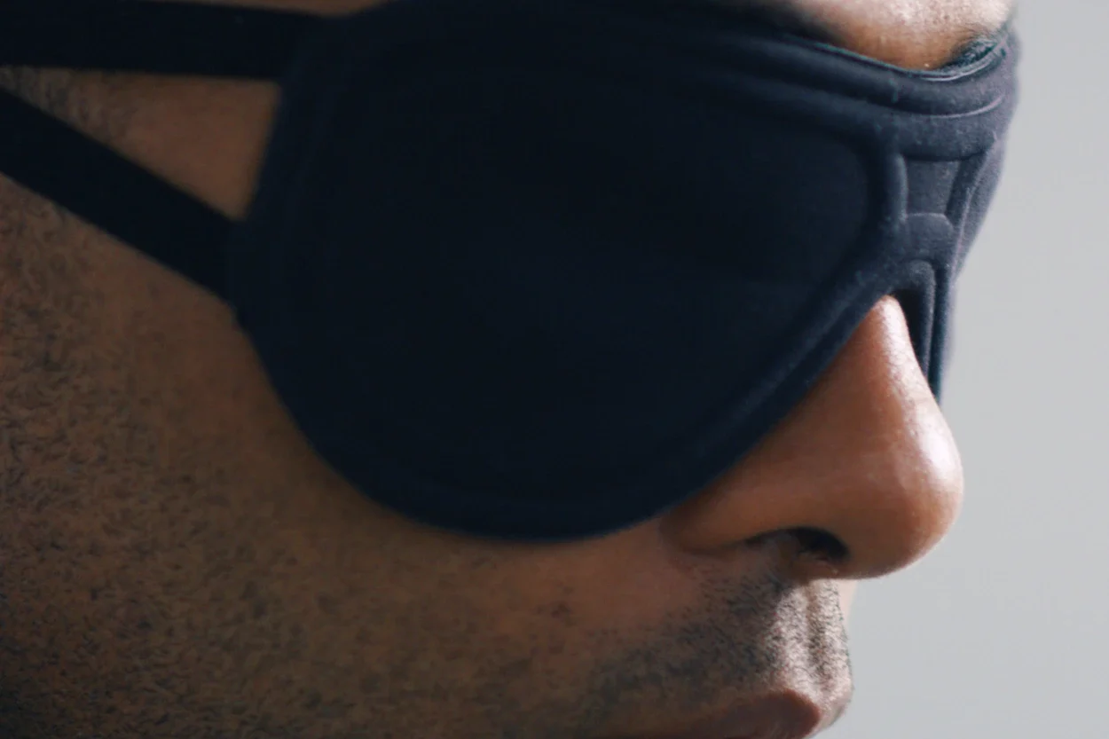 A man wearing a sleep mask from The Inactive Co.