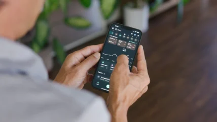 A man with his phone in his hand interacting with the Levels app.