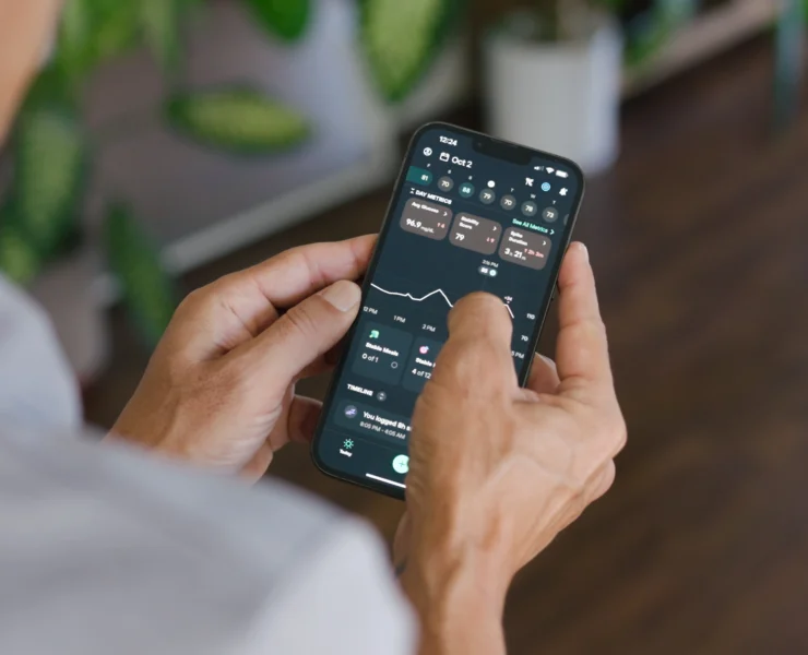 A man with his phone in his hand interacting with the Levels app.