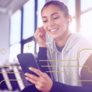 woman listening to earbuds while holding phone
