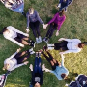 A group of women in a circle with strollers and babies.