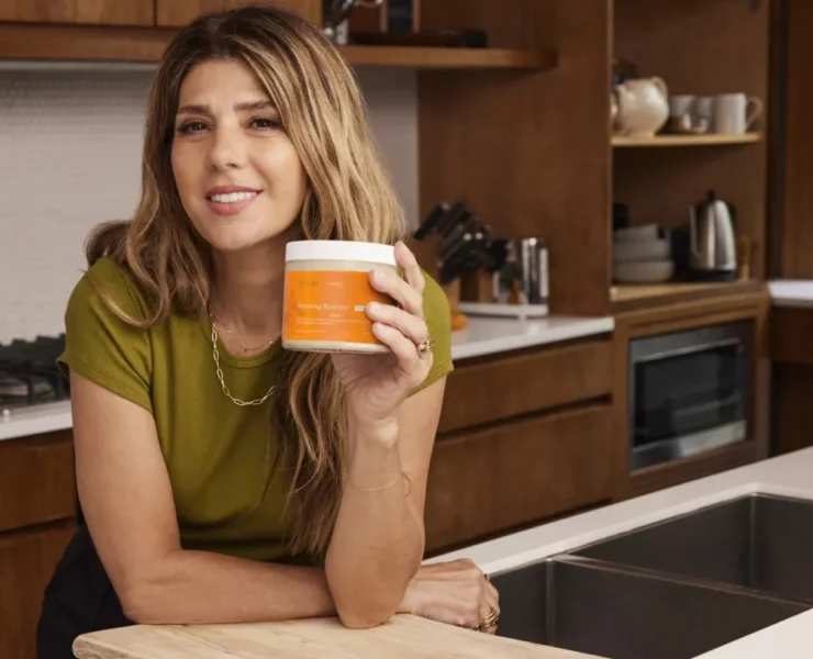 Marisa Tomei holding a jar of Terra Mare in a kitchen.