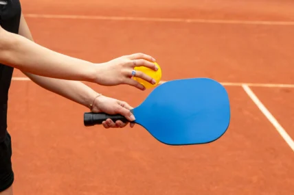 A woman on a pickleball court holding a paddle