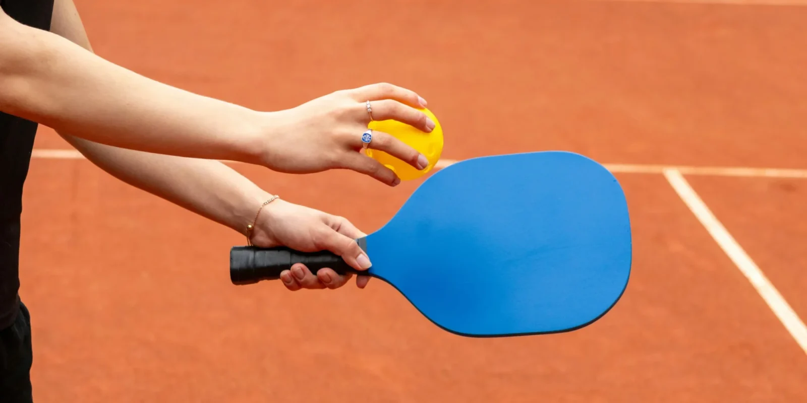 A woman on a pickleball court holding a paddle