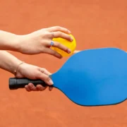 A woman on a pickleball court holding a paddle