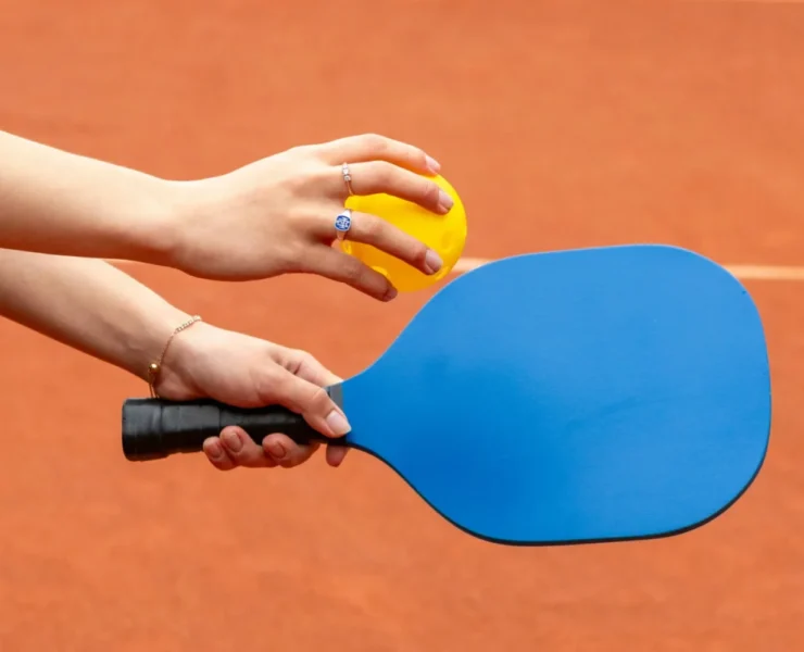 A woman on a pickleball court holding a paddle