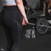 Young woman lifting at the gym.