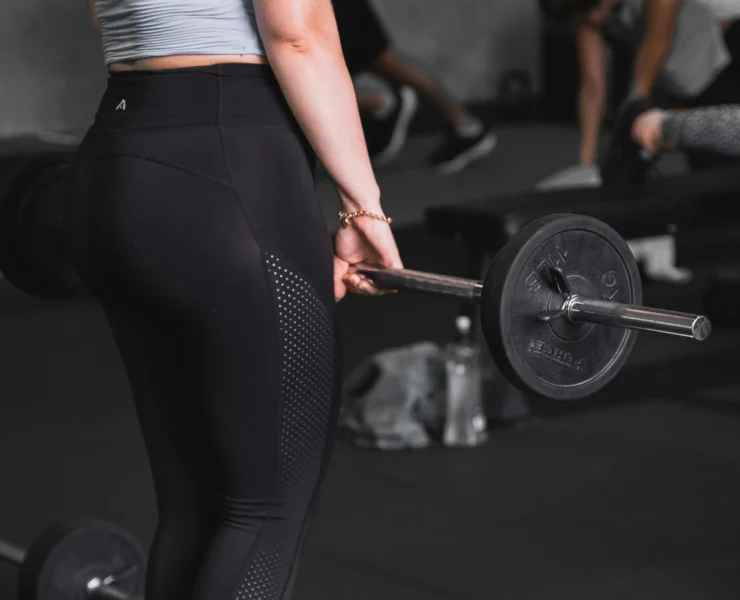Young woman lifting at the gym.