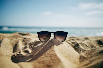 sunglasses in the sand at the beach