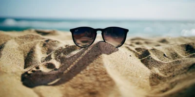sunglasses in the sand at the beach