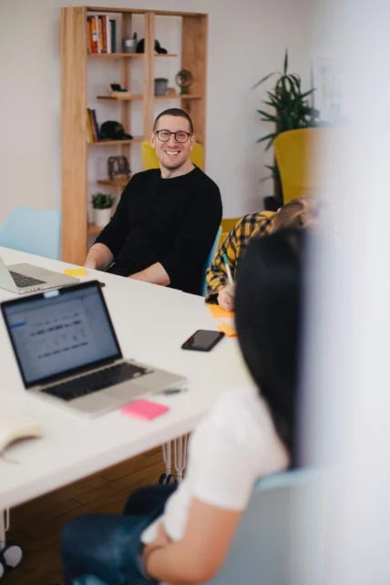 A smiling man in an office setting.