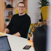 A smiling man in an office setting.