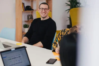 A smiling man in an office setting.
