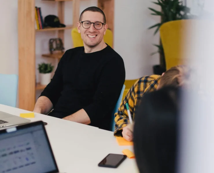 A smiling man in an office setting.