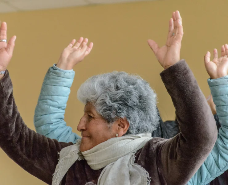 active senior with hands in the air like she just doesn't care