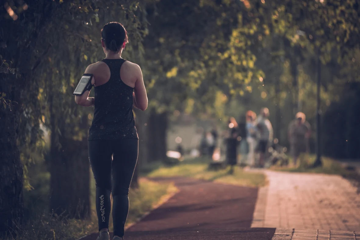 A woman running on a trail.