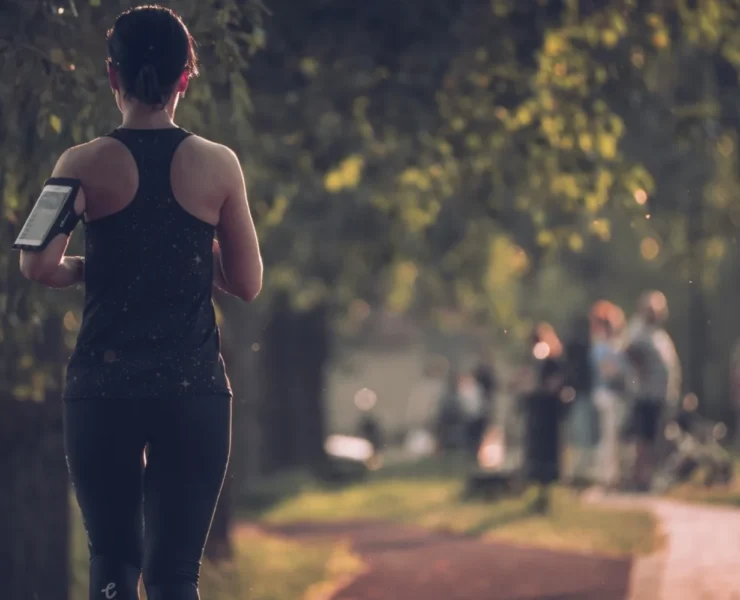 A woman running on a trail.