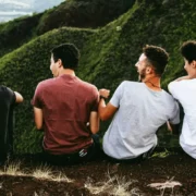Four men enjoying the view on a hill.