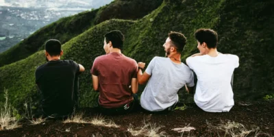 Four men enjoying the view on a hill.