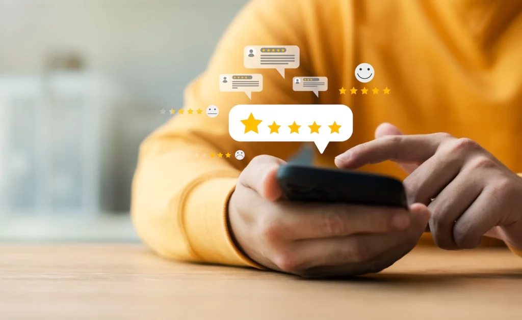 man leaves an online review on his smartphone