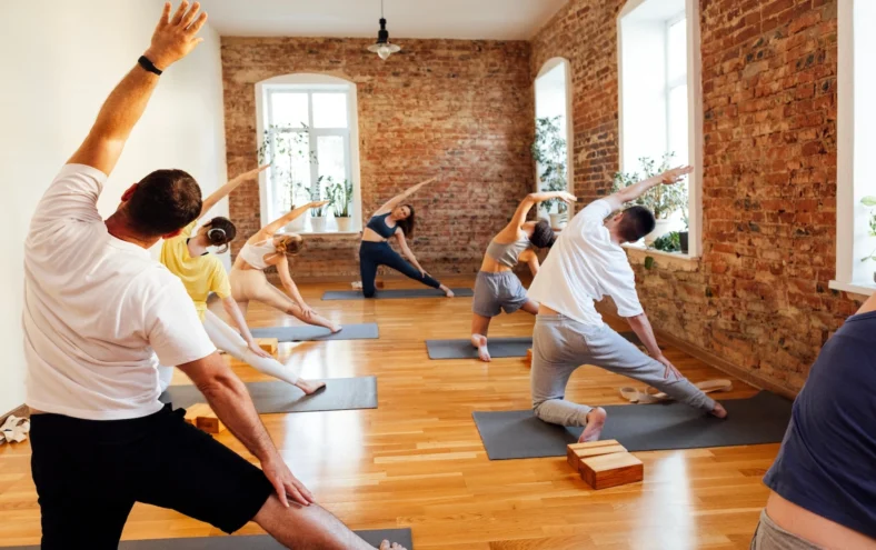 people pose inside a yoga studio