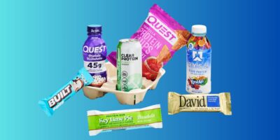a collection of different protein items including shakes, bars, chips, and drinks