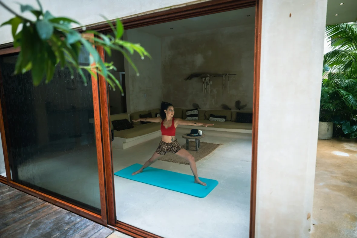 A woman doing yoga in a relaxing-looking space.