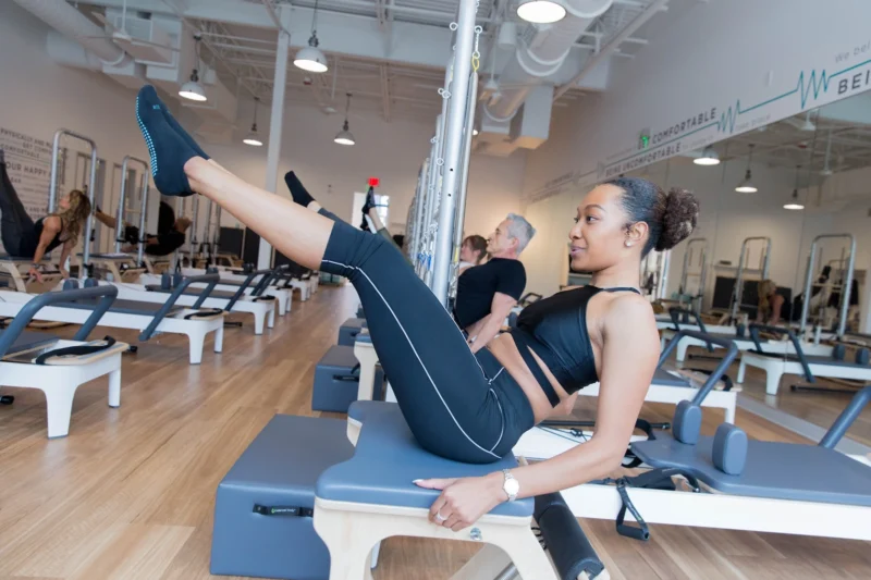 woman working out on a Pilates reformer