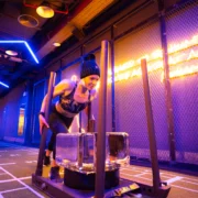 A female pushing a block of ice on a sled