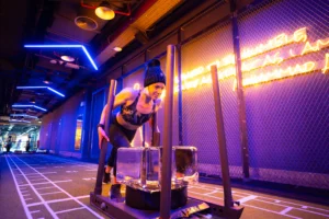A female pushing a block of ice on a sled