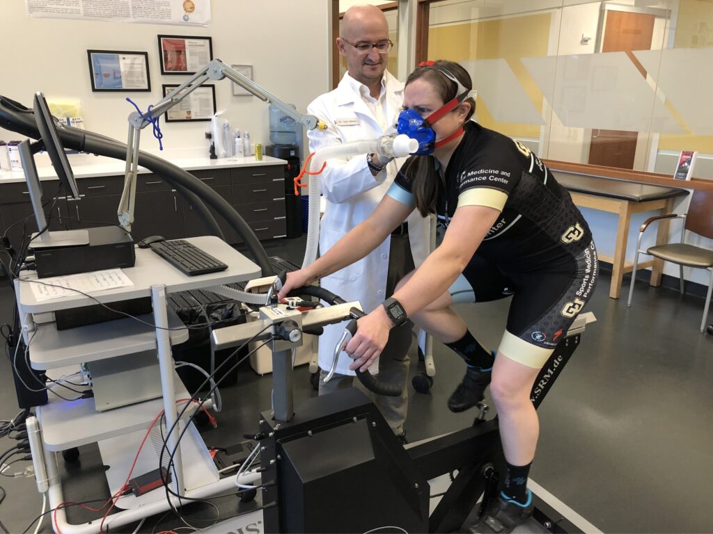 Dr. Iñigo San Millán in the lab with a cyclist