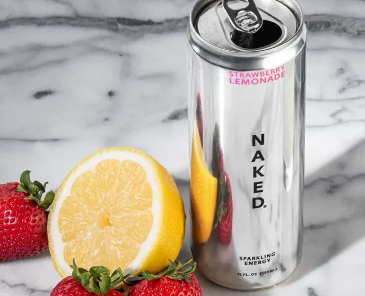 a can of Naked Sparking Energy alongside a lemon and strawberries.
