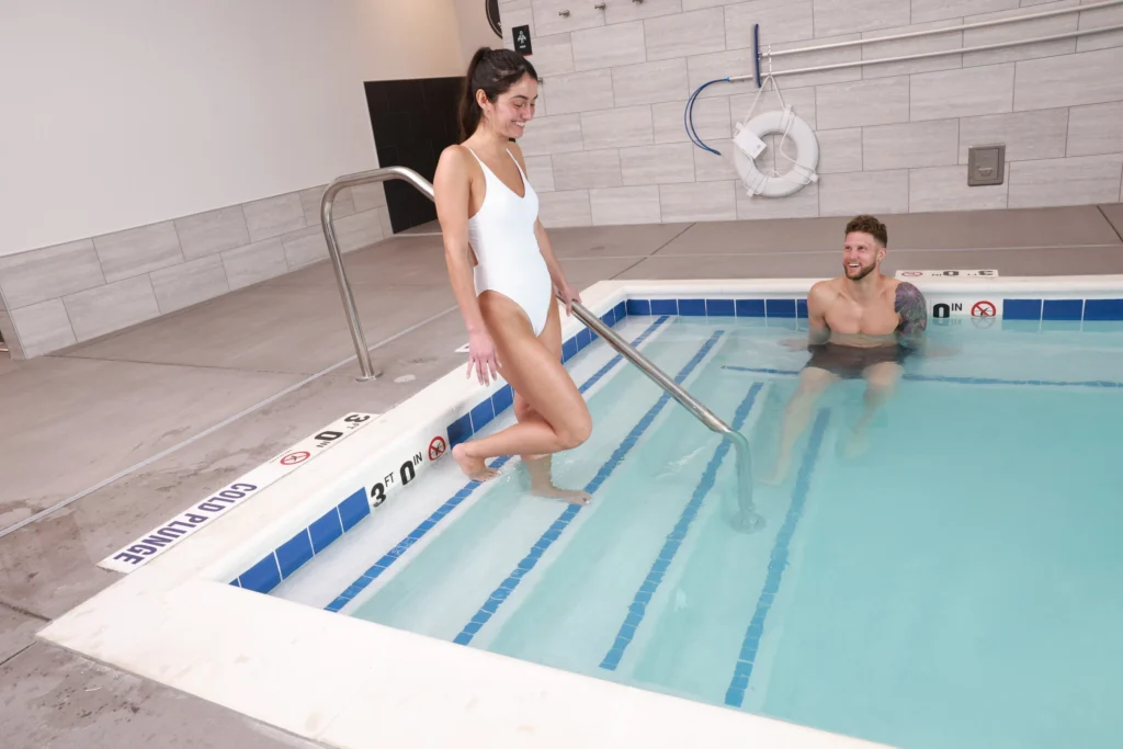 A woman entering a pool