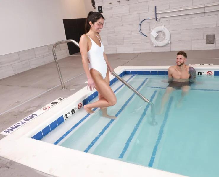 A woman entering a pool