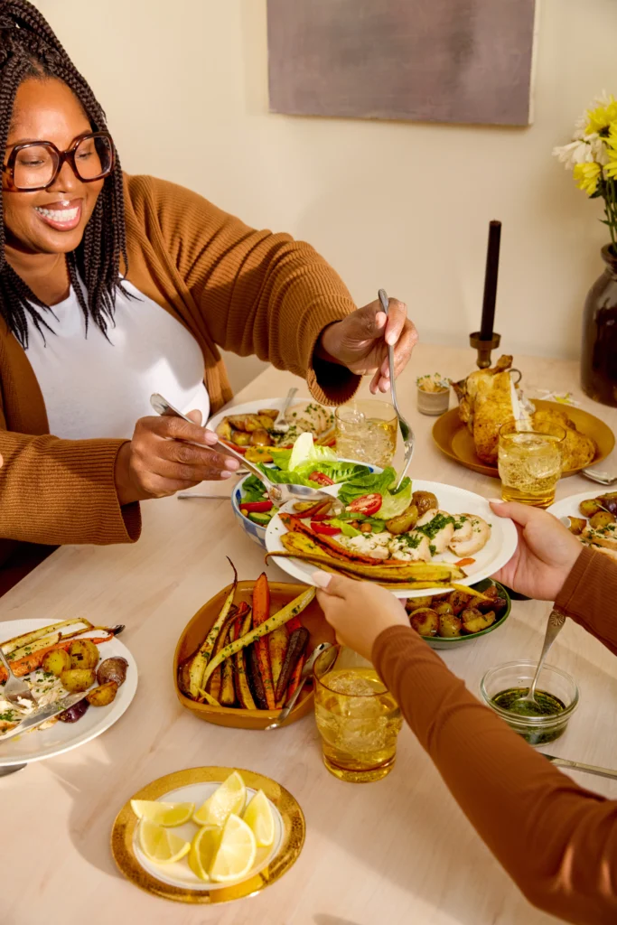 women sharing food at a table.