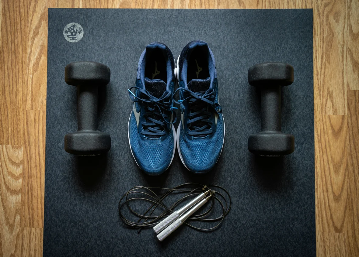 sneakers and workout equipment on a mat