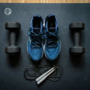 sneakers and workout equipment on a mat