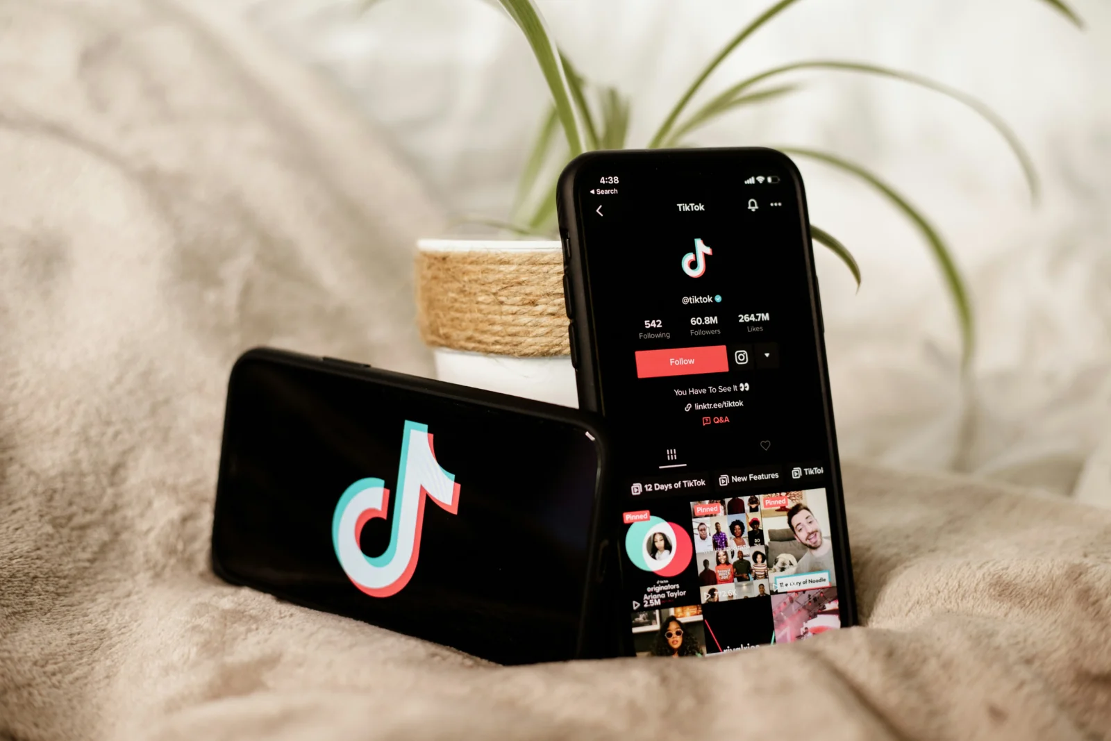 phones on bed with the TikTok app opened