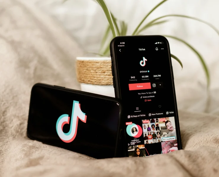 phones on bed with the TikTok app opened