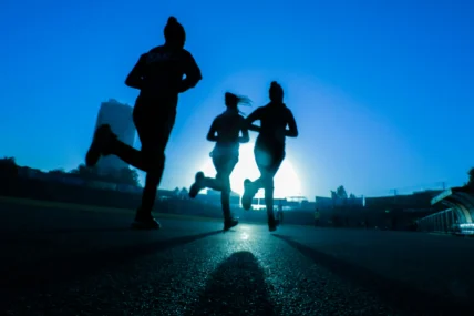 women running in blue light