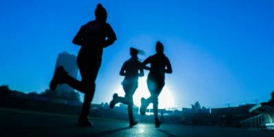women running in blue light