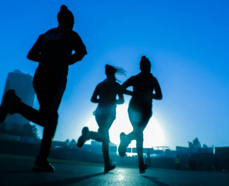 women running in blue light