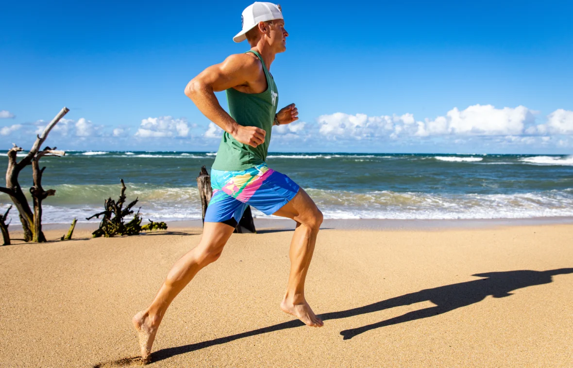 man runs on the beach in an iFIT workout video